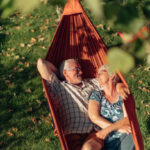 senior couple bonding on the hammock. free time together. positive retired people.